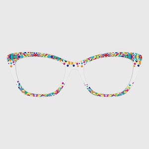 May include: Cat-eye glasses featuring a white frame covered in a vibrant, multi-colored polka dot pattern. The dots appear in various sizes and colors, including blue, yellow, pink, green, and orange, distributed across the entire frame front.