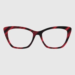 May include: Cat-eye style eyeglasses with a red and black striped pattern. The frames have a bold, angular shape with clear lenses. The glasses are set against a plain background.