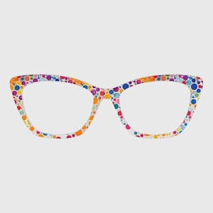 May include: Cat-eye spectacles with a white frame adorned with vibrant polka dots. The dots feature a spectrum of colours, including red, orange, yellow, green, blue, and purple. The lenses are clear, and the glasses are presented on a plain backdrop.
