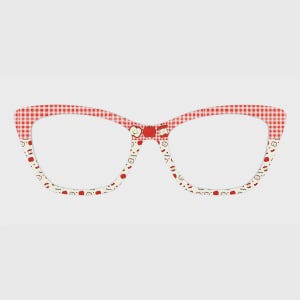 May include: Cat-eye glasses frames featuring a red and white gingham pattern on the upper rims and a white lower rim decorated with small red apple illustrations and the word apple printed in a repeating pattern across the frame surface.