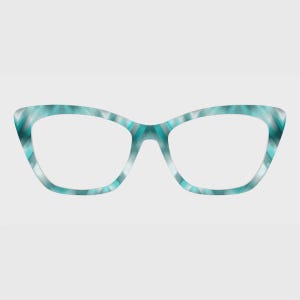 May include: Cat-eye glasses featuring a frame with a gradient pattern of teal, turquoise, and white. The design displays a repeating geometric chevron-like motif across the entire surface of the rims and the bridge, creating a vibrant visual effect.