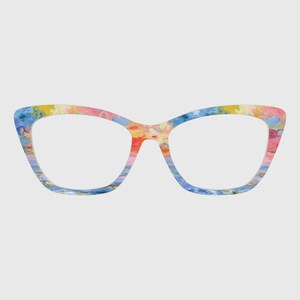 May include: Cat-eye style eyeglasses with a colorful, abstract pattern. The frames feature a blend of blue, yellow, pink, and orange hues, creating a vibrant and artistic design. The lenses are clear, and the overall aesthetic is modern and stylish.