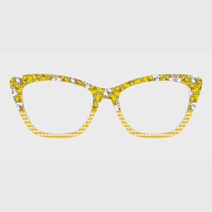 May include: Cat-eye glasses frames featuring a yellow and white rubber duck pattern on the upper rims and a yellow and white gingham check pattern on the lower rims. The frames have a distinct winged shape at the outer corners and clear lenses.