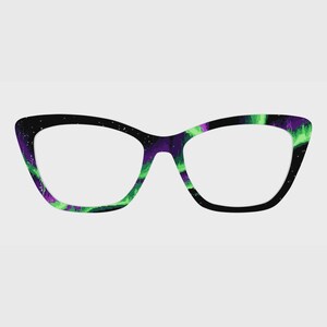 May include: Cat-eye glasses with a black frame featuring a vibrant pattern of green and purple streaks resembling the aurora borealis against a dark night sky with small white dots representing stars across the entire surface of the frame.