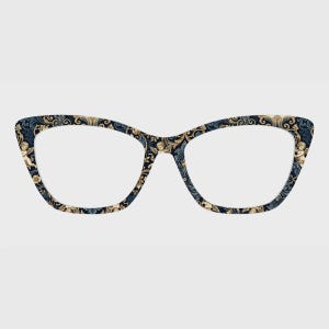 May include: Cat-eye glasses frames featuring a dark blue and gold ornate baroque pattern. The design includes intricate scrolling acanthus leaves and small cherub figures integrated into the decorative print across the entire front rim.