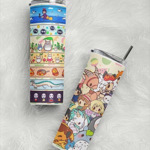 May include: Two stainless steel tumblers with colorful anime-style character designs. One features a layered design with characters and scenes, including a witch on a broom. The other tumbler has a collage of anime characters.