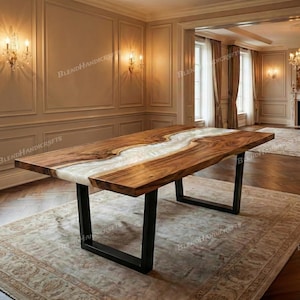 May include: A large, rectangular wooden dining table with a live edge design. The table features a river of white epoxy resin running down the center. The table is supported by black metal legs. The table is approximately 96 inches long.