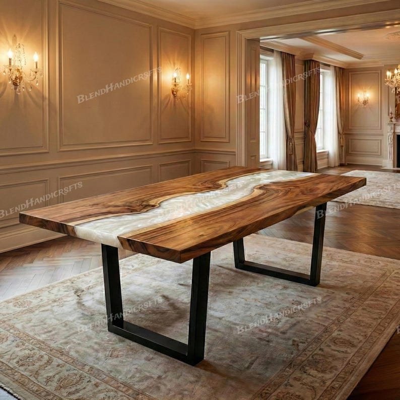 May include: A large, rectangular wooden dining table with a live edge design. The table features a river of white epoxy resin running down the center. The table is supported by black metal legs. The table is approximately 96 inches long.