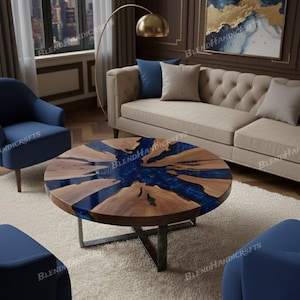 May include: Round wooden coffee table with a dark blue epoxy resin center. The table has a natural wood grain pattern and sits on a dark metal base. The table is approximately 40 inches in diameter.
