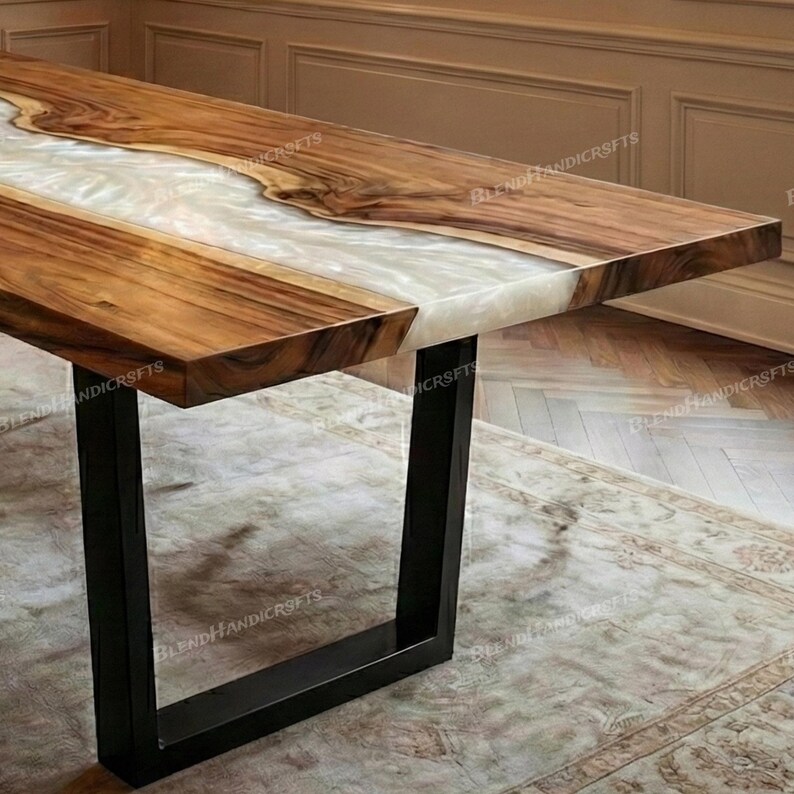 May include: A rectangular wooden table with a white resin center. The table has a dark brown wood grain and black metal legs. The table is a modern design and would be suitable for a dining room.