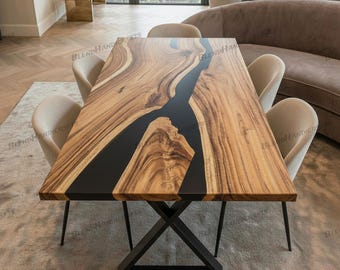 May include: A rectangular wooden dining table with a black epoxy river design. The table has a natural wood grain finish and sits on a black metal base. The table is surrounded by beige chairs.
