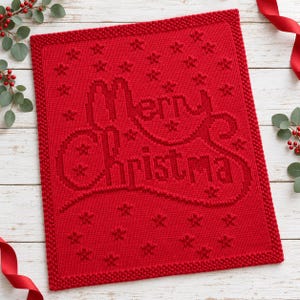 May include: A rectangular red knitted blanket featuring the text Merry Christmas in a raised, textured knit pattern. The design is surrounded by small, embossed star motifs and finished with a wide, bumpy garter stitch border.
