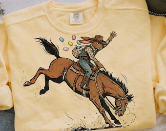 Vaquero de Pascua PNG con divertido diseño de camiseta de primavera occidental de vaquero montando un ciervo. Feliz Pascua PNG. Descarga digital.