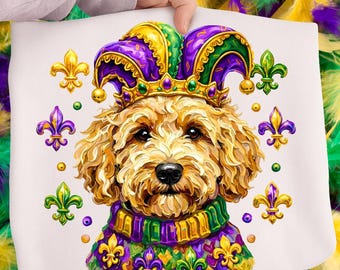May include: A white pillow featuring a golden doodle wearing a Mardi Gras jester hat and collar. The hat is purple and green with gold trim, and the collar is green, purple, and gold. Fleur-de-lis symbols surround the dog.