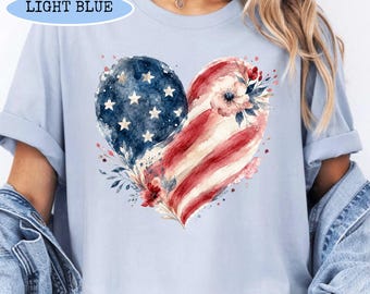 Maglietta minimalista con cuore e stampa patriottica, semplice t-shirt con bandiera americana stilizzata, outfit moderno e discreto per il 4 luglio, t-shirt estetica per l'orgoglio militare.