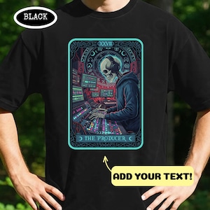 May include: Black t-shirt with a tarot card graphic. The card depicts a skeleton DJ with headphones, operating audio equipment, and reads "THE PRODUCER" and "XXVII". There is space to "ADD YOUR TEXT!"