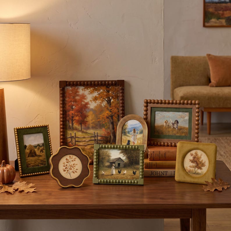May include: A collection of various picture frames featuring beaded, scalloped, and smooth edges in shades of brown, green, and gold. The frames contain artwork depicting rural landscapes, trees, a person with a dog, and chickens near a shed.