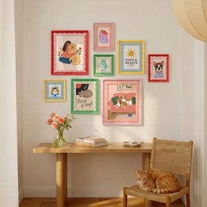 May include: A gallery wall featuring eight colourful scalloped frames containing various animal-themed illustrations, including a dog with a person, a cat, and a French bulldog. The text Paws & Hearts Club and Purrs & Vinyl is visible on two prints.