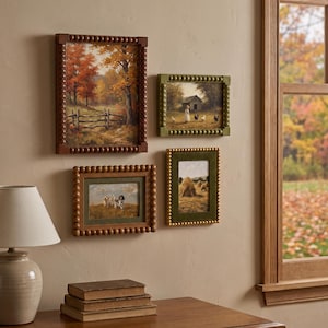 May include: Four framed wall art pieces featuring rural landscapes and animals. The frames have a beaded texture in brown, olive green, and gold. The prints depict an autumn forest, a farm scene with chickens, dogs in a field, and haystacks.