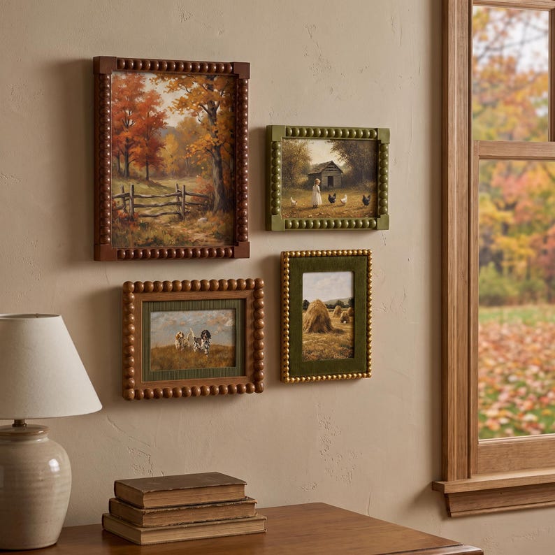 May include: Four framed wall art pieces featuring rural landscapes and animals. The frames have a beaded texture in brown, olive green, and gold. The prints depict an autumn forest, a farm scene with chickens, dogs in a field, and haystacks.