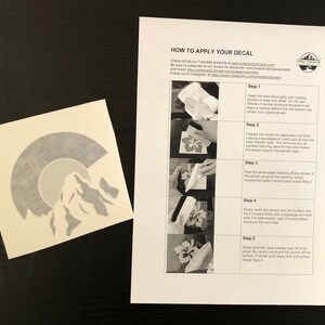 May include: Instructions on how to apply a decal. The instructions include five steps: cleaning the area, preparing the sticker, peeling the backing, applying the sticker, and removing the transfer tape.