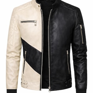 May include: A two-tone leather jacket in cream and black. The jacket has a stand-up collar, multiple zipped pockets, and the brand name "ZADVO" on the collar. The design is a colour block pattern.