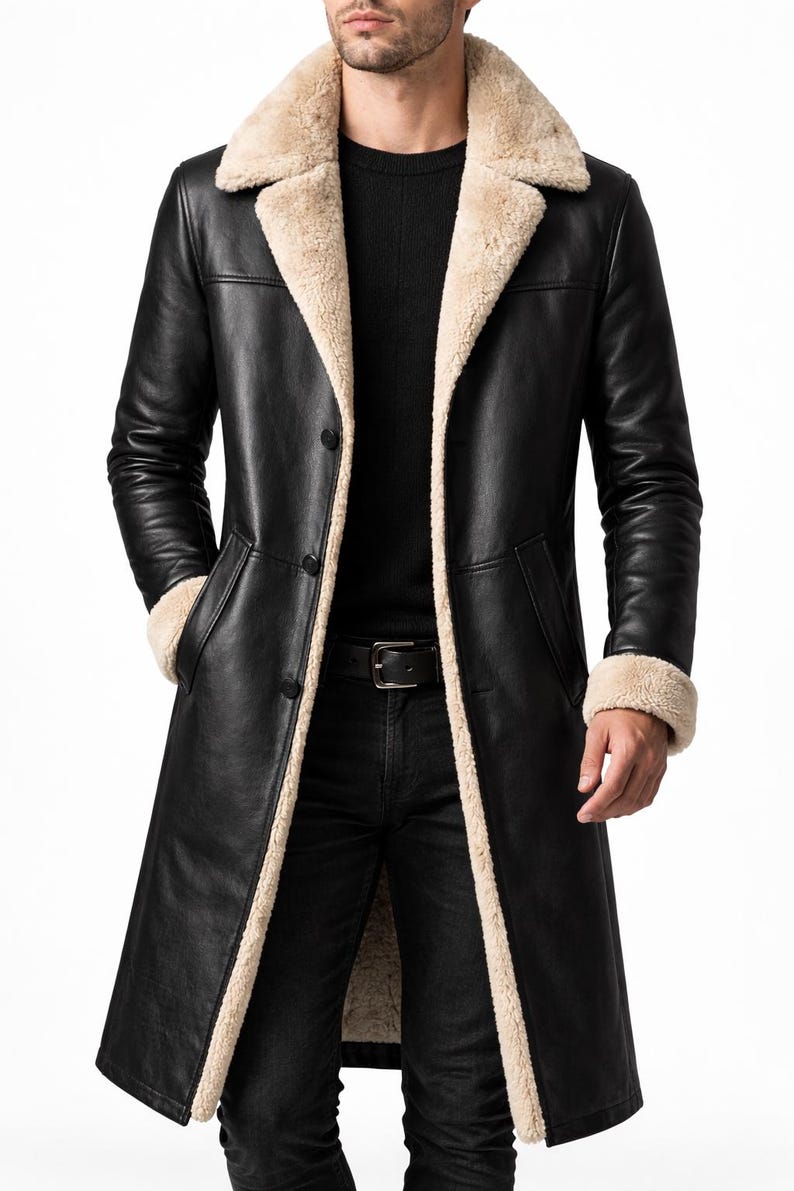 May include: A long black leather coat with a beige shearling collar and lining. The coat has a button closure, pockets, and a belt. The coat is a classic outerwear piece.