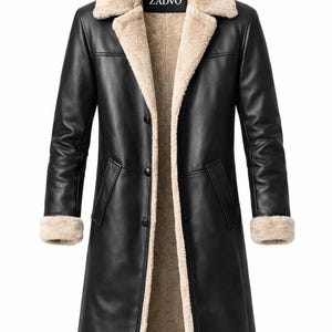 May include: Black leather coat with a beige shearling lining and collar. The coat has a classic design with a button closure, long sleeves, and a knee-length hem. The brand name "ZADVO" is visible on the collar.