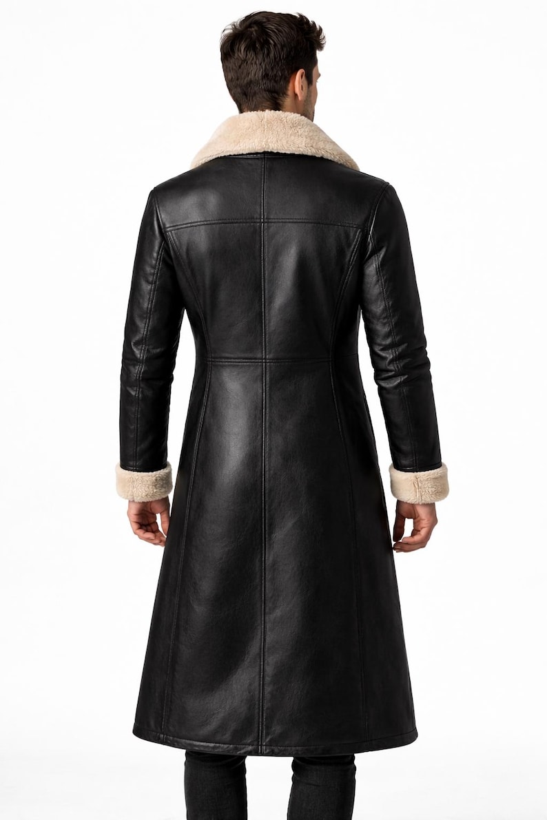 May include: Black leather coat with a cream-colored shearling collar and cuffs. The long coat features a tailored fit with vertical seams and a flared skirt. A classic outerwear piece.