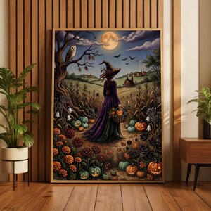 May include: A framed wall art print depicting a witch in a long purple dress and pointed hat standing in a cornfield at night. The scene features a full moon, an owl on a tree, bats, a basket of pumpkins, and orange and black flowers.