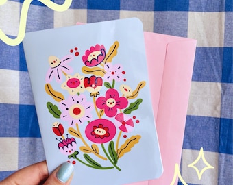 Tarjeta de felicitación A6 con flores – Ilustración original del personaje, interior en blanco