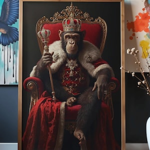 May include: A framed artwork depicts a chimpanzee in regal attire, seated on a red throne. The chimp wears a crown, fur-trimmed robe, and holds a scepter. The background is dark, and the frame is gold.