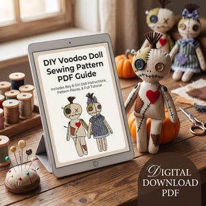 May include: A tablet displaying a DIY Voodoo Doll Sewing Pattern PDF Guide with text and illustrations of two dolls. Beside it sits a beige fabric doll with button eyes, a red heart patch, and stitched details, along with sewing supplies.