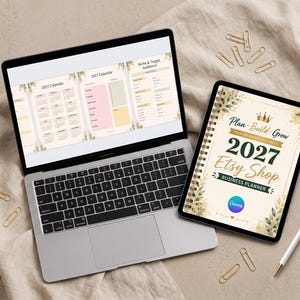 May include: A laptop displaying a 2027 calendar and business planning pages alongside a spiral-bound 2027 Etsy Shop Business Planner. The planner cover features a crown icon, floral accents, and the text Plan Build Grow 2027 Etsy Shop Business Planner.