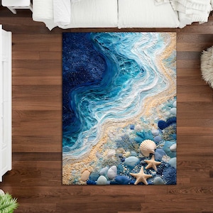 May include: A rectangular rug with a coastal design. The rug features a detailed depiction of ocean waves in shades of blue and white, transitioning to a sandy beach with seashells and starfish. The rug is placed on a wooden floor.