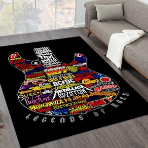 May include: Black rectangular rug featuring a guitar shape filled with rock band logos. Logos include AC/DC, Led Zeppelin, Pink Floyd, and The Who. The words "LEGENDS OF ROCK" are printed at the bottom in white.