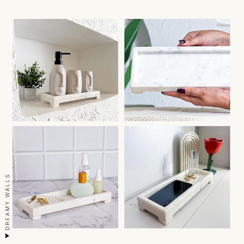 May include: A selection of white marble trays. One holds a soap dispenser and two cups with face designs. Another displays perfume bottles and jewellery. A third tray holds a phone. The trays are rectangular with small feet.