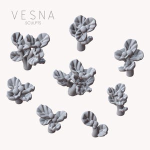 May include: Gray floral sculptures in various arrangements. The sculptures have a detailed petal design and are arranged on a light background. The text "VESNA SCULPTS" is at the top of the image.
