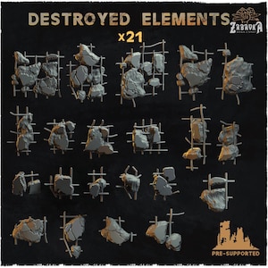 Puede incluir: Un conjunto de 21 piezas de terreno en miniatura de color gris etiquetadas como DESTROYED ELEMENTS, que presentan fragmentos de hormigón irregular unidos a rejillas de varillas de acero. Incluye varias formas de escombros para dioramas.