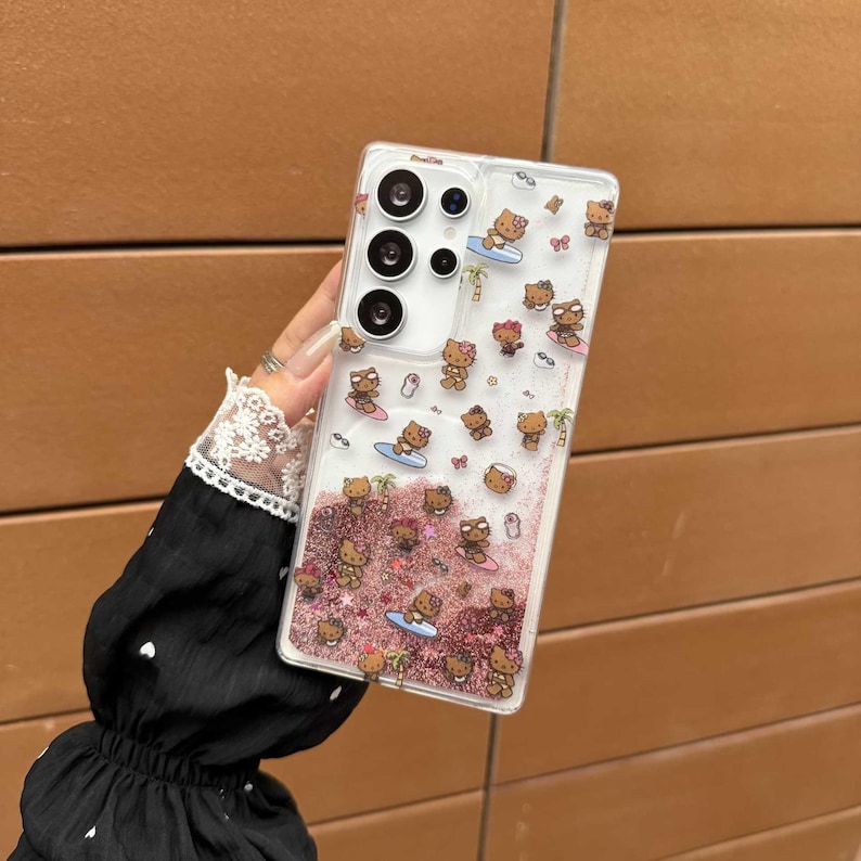 May include: Clear phone case with a beach-themed design. The case features a pattern of brown cartoon characters surfing on blue surfboards, with pink glitter and small clear bubbles. The case has a camera cutout and buttons.