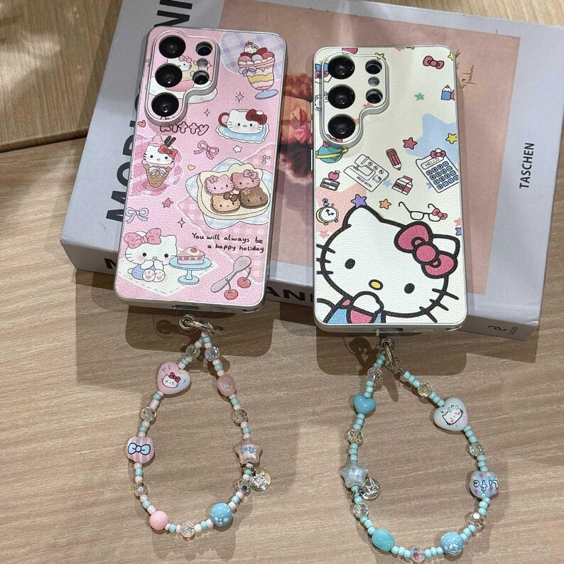 May include: Two phone cases with Hello Kitty designs, one pink and one white, with matching beaded bracelets. The pink case has a dessert theme, while the white case features school supplies. The bracelets have pink, blue, and clear beads.