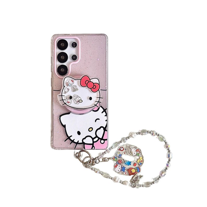 Peut inclure: Coque de t&eacute;l&eacute;phone rose paillet&eacute;e avec un motif Hello Kitty et un n&oelig;ud rouge. Comprend une poign&eacute;e pop-up et un bracelet &agrave; breloques avec un charm Hello Kitty. La coque est con&ccedil;ue pour un smartphone.