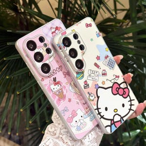 May include: Two phone cases with a Hello Kitty theme. One case is pink with Hello Kitty and dessert illustrations. The other is white with Hello Kitty and school supply illustrations. Both cases have a silver border.