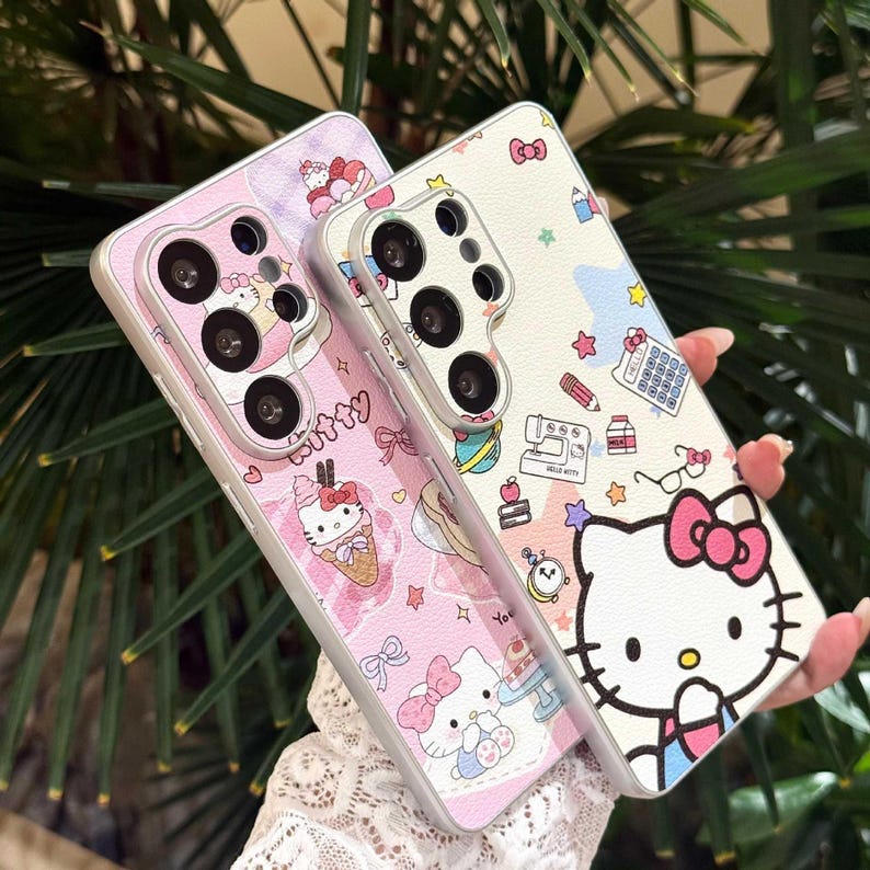 May include: Two phone cases with a Hello Kitty theme. One case is pink with Hello Kitty and dessert illustrations. The other is white with Hello Kitty and school supply illustrations. Both cases have a silver border.