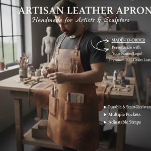 May include: A brown artisan leather apron with multiple pockets and adjustable straps. The apron is handmade for artists and sculptors. The apron has the text "ARTISAN LEATHER APRON Handmade for Artists & Sculptors" at the top. The apron is made of premium full-grain leather.
