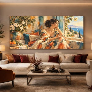 Könnte beinhalten: Ein großer rechteckiger Wandkunstdruck, der eine Person in einem farbenfroh gemusterten Kleid zeigt, die an einem offenen Fenster sitzt und auf eine mediterrane Küstenlandschaft blickt, mit weißen Blumen in einer Vase und Orangen.