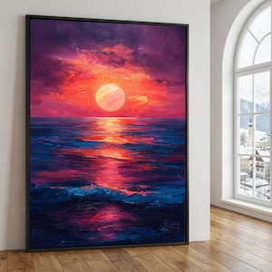 May include: A framed canvas art print showing a sunset over the sea. The sky is a blend of purple, red, and orange, with a large, radiant sun. The ocean mirrors the sky's colours, with shades of blue, red, and purple, creating a dramatic scene.