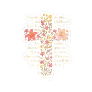 May include: A sticker in the shape of a cross, adorned with colorful flowers and foliage. The design includes text from Luke 12:27, in a soft, elegant font. The flowers are in shades of pink, peach, and yellow.