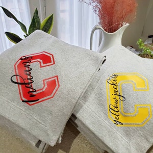 Cozy sweatshirt blankets customized for your favorite school or team!