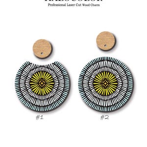 May include: Laser-cut wooden earrings with a circular pattern. The earrings have a yellow centre, encircled by white and black lines, with a light blue border. The top of the earrings are small, round, wooden pieces. The text "HALOCOLOR" and "www.halocolor.etsy.com" are visible.